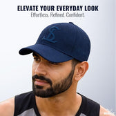 Man wearing a navy blue cap with a logo, against a light gray background.