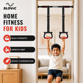 A child hanging from a wall-mounted pull-up bar set with two black straps and red handles, shown in a home interior. The left side includes the brand name SLOVIC, large text reading 'HOME FITNESS FOR KIDS,' and three benefit callouts about building strength, improving grip, and boosting coordination.