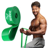 Tiger Shroff holding a green resistance band with SLOVIC branding on a white background